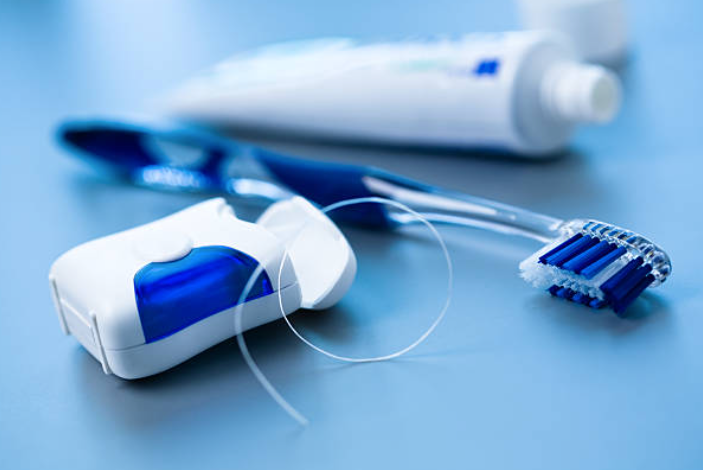 A photo of floss and a tooth brush A photo of floss and a tooth brush