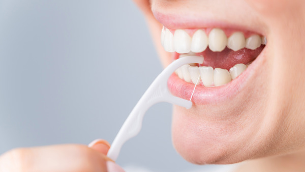 Woman using a flosser for her teeth